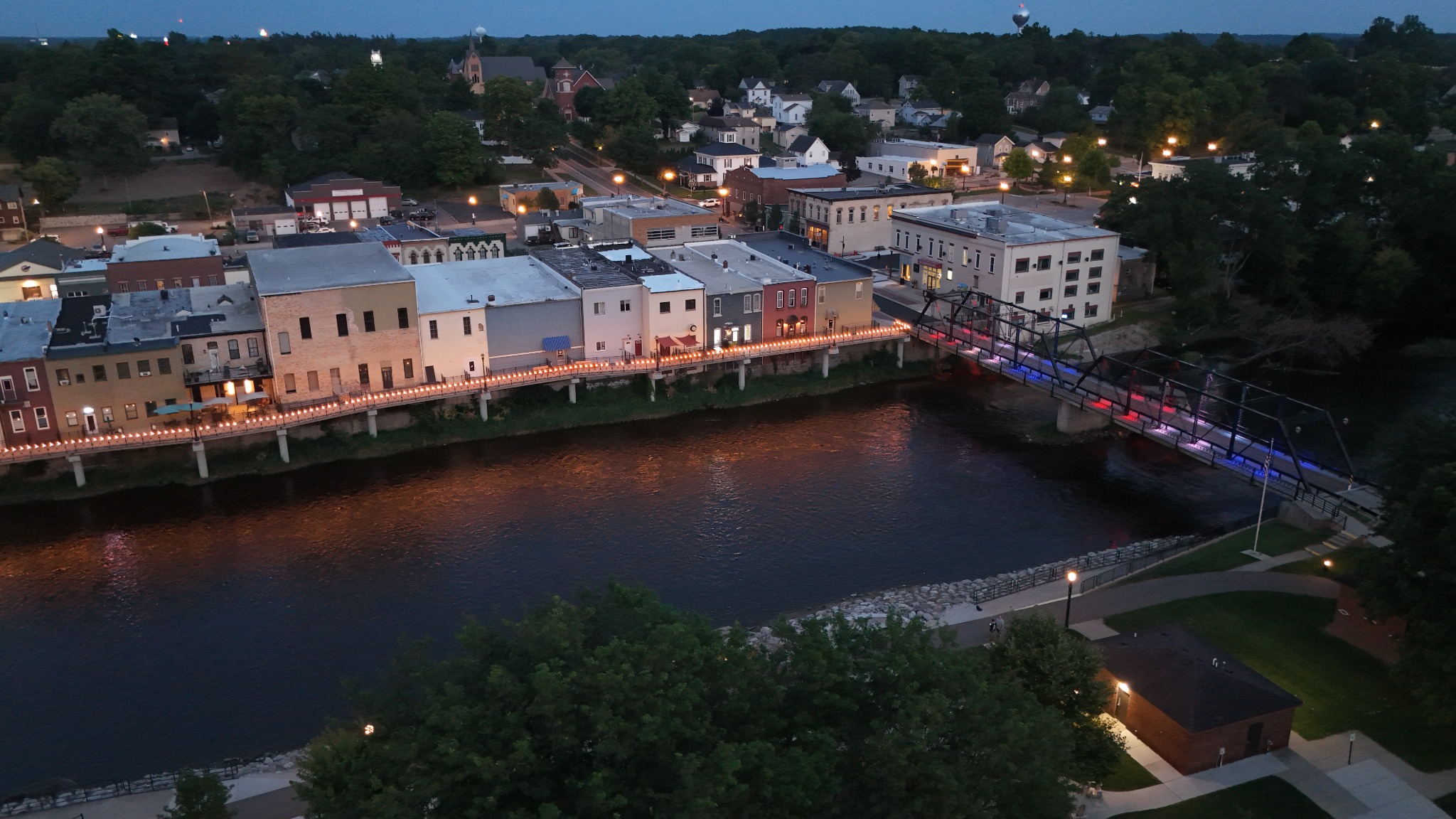 Aerial twilight view of a riverfront downtown and bridge